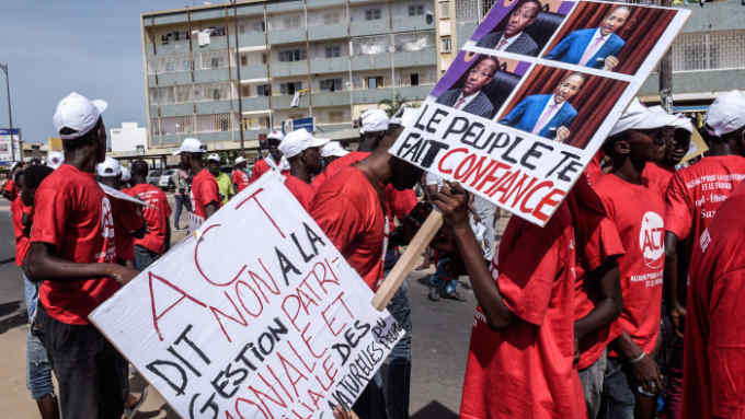 Protesters rally in Dakar on October 14, 2016. Police dispersed in Dakar Friday march of the Senegalese opposition to greater transparency in the management of gas discovered in the country, hours after the resignation of an oil company of a brother of President Macky Sall targeted by criticism. / AFP / SEYLLOU (Photo credit should read SEYLLOU/AFP/Getty Images)