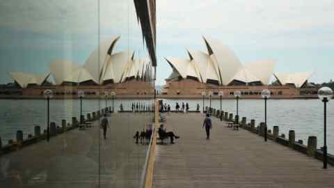 A reflection of the Sydney Opera House is seen in a window in Sydney, Australia, on Friday, April 29, 2016. Australia’s drive to balance the books will see the federal government’s debt pile top out within about five or six years and then start to shrink again, according to Treasurer Scott Morrison. Photographer: Brendon Thorne/Bloomberg