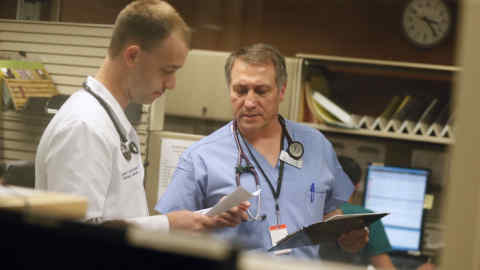 Emergency room physicians Dr. Patrick Odens (resident) left and Dr. David Peterson looked over a patient chart at Abbott Northwestern Hospital Wednesday May 13, 2015 in Minneapolis, MN. Peterson has been a doctor at Abbott Northwestern since 1984. ] Jerry Holt/ Jerry.Holt@Startribune.com (Photo By Jerry Holt/Star Tribune via Getty Images)