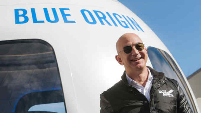 Jeff Bezos, chief executive officer of Amazon.com Inc. and founder of Blue Origin LLC, smiles while speaking at the unveiling of the Blue Origin New Shepard system during the Space Symposium in Colorado Springs, Colorado, U.S., on Wednesday, April 5, 2017