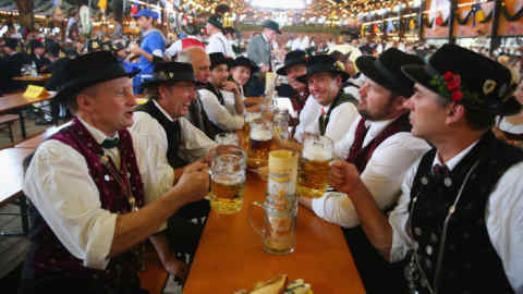 Oktoberfest 2014 - Day Two...MUNICH, GERMANY - SEPTEMBER 21: Men in their traditional Bavarian clothing clink beer mugs after the Parade of Costumes and Riflemen (Trachten- und Schuetzenzug) on the second day of the 2014 Oktoberfest at Theresienhoehe on September 21, 2014 in Munich, Germany. The 181st Oktoberfest will be open to the public from September 20 through October 5 and traditionally draws millions of visitors from across the globe in the world's largest beer fest. (Photo by Alexander Hassenstein/Getty Images)