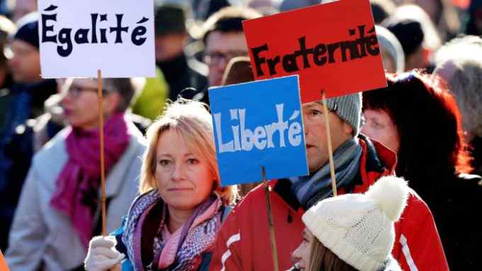 Demonstrators holding placards with the inscriptions in French &quot;Egalite&quot;, &quot;Liberte&quot; and &quot;Fraternite&quot; (equality, freedom and fraternity) protest against a meeting of the main leaders of Europe's populist and far-right parties in Koblenz, western Germany, on January 21, 2017.
French presidential hopeful Marine Le Pen is leading the European gathering of right-wing populist parties in a show of strength ahead of crucial elections across the region this year. The congress will also feature Geert Wilders of the Dutch far-right Freedom Party, Frauke Petry of the anti-migrant Alternative for Germany (AfD) and Matteo Salvini of Italy's xenophobic Northern League.
 / AFP / dpa / Susann Prautsch / Germany OUT        (Photo credit should read SUSANN PRAUTSCH/AFP/Getty Images)