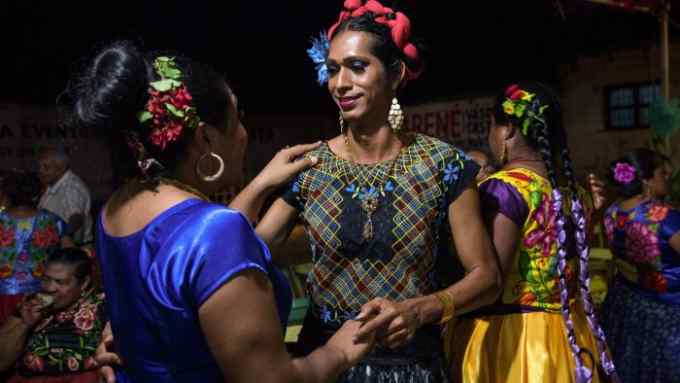 Estrella Velásquez Guerra (R), 36, dances with Darina Guerra Carballo (L), 32, at a traditional birthday party of a close family friend in Juchitán de Zaragoza, Mexico on October 4, 2018. Darina is a muxe from Juchitán de Zaragoza, Mexico. She works as a dressmaker and lives with her boyfriend Jesús Gómez Reyes, 29. Having an older sibling who is a muxe made life easier for her. “Deep down, I feel like a woman but I recognise I am a muxe,” she says. She has been dressing as a woman for a decade. “My dad still calls me by my real name. He doesn’t make me do men’s work but he can’t bring himself to call me by a girl’s name.”Estrella is the director of sexual diversity at the town hall in Juchitán de Zaragoza, Mexico, where she goes dressed in traditional Zapotec long skirts and blouses. “I love people to turn round and look at me,” she says. “There still is homophobia. There are some men who don’t accept us in offices and other public places,” she says. Photo by Bénédicte Desrus