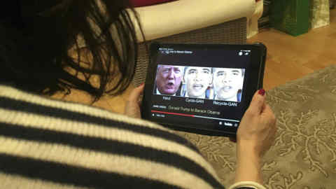 A woman in Washington, DC, views a manipulated video on January 24, 2019, that changes what is said by President Donald Trump and former president Barack Obama, illustrating how “deepfake” technology can deceive viewers. - &quot;Deepfake&quot; videos that manipulate reality are becoming more sophisticated and realistic as a result of advances in artificial intelligence, creating a potential for new kinds of misinformation with devastating consequences. (Photo by Rob Lever / AFP) / TO GO WITH AFP STORY by Rob LEVER &quot;Misinformation woes may multiply with ‘deepfake’ videos&quot;