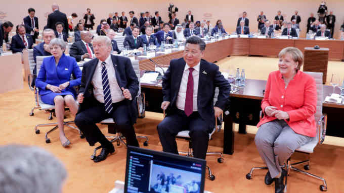 (R-L) German Chancellor Angela Merkel, China's President Xi Jinping, US President Donald Trump, Britain's Prime Minister Theresa May, Turkey's President Recep Tayyip Erdogan, South Africa's President Jacob Zuma and Russia's President Vladimir Putin are pictured at the start of the first working session of the G20 meeting in Hamburg, northern Germany, on July 7. Leaders of the world's top economies will gather from July 7 to 8, 2017 in Germany for likely the stormiest G20 summit in years, with disagreements ranging from wars to climate change and global trade. / AFP PHOTO / POOL / Kay Nietfeld (Photo credit should read KAY NIETFELD/AFP/Getty Images)