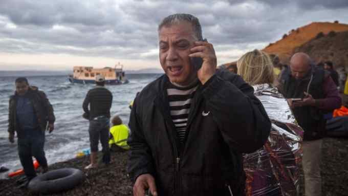 A man talks on his cell phone with his family immediately after disembarking from a boat from Turkish coast to the Greek island of Lesbos, Thursday, Oct. 29, 2015. Europe's largest refugee crisis since World War II is entering a perilous and uncharted phase, as the usual pattern of migrant season ending by autumn is overturned by intensifying fighting in Syria and overcrowding in refugee centers in Turkey and Lebanon. (AP Photo/Santi Palacios)