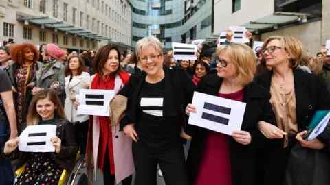 Journalist Carrie Gracie (centre) and BBC employees gather outside Broadcasting House in London, to highlight equal pay on International Women's Day.