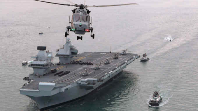 Pictured is Britain's future flagship, HMS Queen Elizabeth as she sailed into her home port of Portsmouth for the first time. Greeted by thousands of people lining the Portsmouth seafront, the 65,000-tonne carrier was met with the warmest of welcomes as she arrived in her home port. Royal Navy sailors lined up in ceremonial procedure on the flight deck of the mammoth ship, standing alongside civilian colleagues from the Aircraft Carrier Alliance, as she passed the Round Tower. The ship will berth at the newly-opened Princess Royal Jetty at Her Majesty's Naval Base Portsmouth, which will be home to both of the Royal Navy's new aircraft carriers. The second, HMS Prince of Wales, will be officially named in a ceremobaum FRPU(E)
