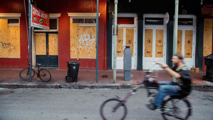 A cyclist rides past shops temporarily closed in the French Quarter neighborhood of New Orleans, Louisiana, U.S., on Saturday, May 16, 2020. Louisiana entered its phase 1 of reopening on Friday after Governor John Bel Edwards loosened restrictions on certain business in the state. Photographer: Bryan Tarnowski/Bloomberg