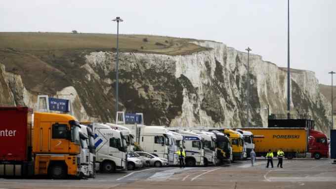 Lorries line up in front of the White Cliffs of Dover, at the Dover ferry terminal, Britain February 20, 2016. Stand on top of the white cliffs of Dover on a clear day and you can see the French coast and the constant traffic of ferries crossing the Channel, binding Britain and Europe through the flow of people and goods. Seen through many British eyes, the famous cliffs conjure up a different vision, that of a fiercely independent island nation with a nearly thousand-year history of repelling would-be invaders from the continent just 33 km (21 miles) away. The tension between these two facets of British identity goes a long way to explain the country's tetchy relationship with the European Union, which will come to a head in a looming referendum on whether to withdraw from the bloc. Photograph taken on February 20, 2016. REUTERS/Phil Noble - RTX27WB7