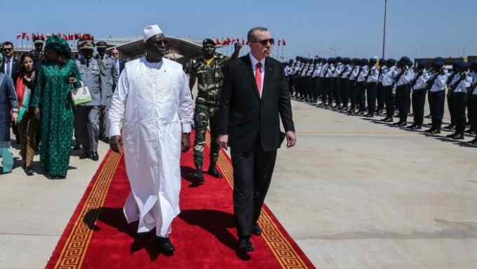 Turkish President Recep Tayyip Erdogan, right, and Senegalese President Macky Sall review a military honour guard before leaving for neighbouring Mali, in Dakar, Senegal, Friday, March 2, 2018. Erdogan is in Senegal for a two-day visit aimed at boosting the political and economic cooperation between the two countries.(Kayhan Ozer/Pool Photo via AP)