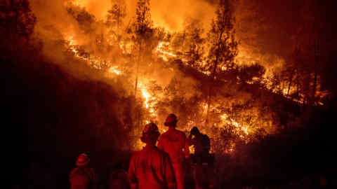 FILE - In this Aug. 7, 2018 file photo, firefighters monitor a backfire while battling the Ranch Fire, part of the Mendocino Complex Fire, near Ladoga, Calif. A Northern California fire department says a telecommunication's company hobbled Internet communications at a crucial command center set up to fight one of the state's largest wildfires. Radio station KQED reported Wednesday, Aug. 22, 2018 that Verizon acknowledged it wrongly limited data speed to the Santa Clara County Fire Department while its firefighters helped battle the state's largest-ever wildfire in Mendocino County three weeks ago. (AP Photo/Noah Berger, File)