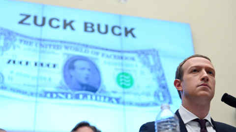 Facebook Chairman and CEO Mark Zuckerberg testifies in front of a projection of a &quot;Zuck Buck&quot; at a House Financial Services Committee hearing examining the company's plan to launch a digital currency on Capitol Hill in Washington, U.S., October 23, 2019. REUTERS/Erin Scott