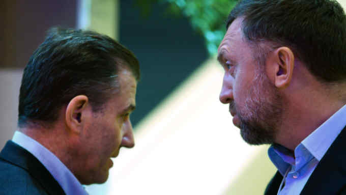 Ivan Glasenberg, billionaire and chief executive officer of Glencore Xstrata Plc, left, speaks with Oleg Deripaska, billionaire and chief executive officer of United Co. Rusal, during a break in sessions on the opening day of the World Economic Forum (WEF) in Davos, Switzerland, on Wednesday, Jan. 21, 2015. World leaders, influential executives, bankers and policy makers attend the 45th annual meeting of the World Economic Forum in Davos from Jan. 21-24. Photographer: Chris Ratcliffe/Bloomberg