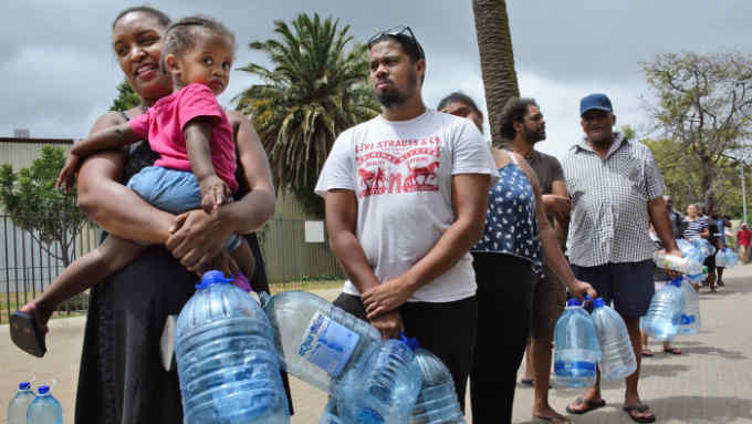 People wait in line for water in Cape Town on Feb. 16, 2018. In June, the South African city is expected to become the first major world city to completely run out of water, according to media reports. (Kyodo) ==Kyodo (Photo by Kyodo News via Getty Images)
