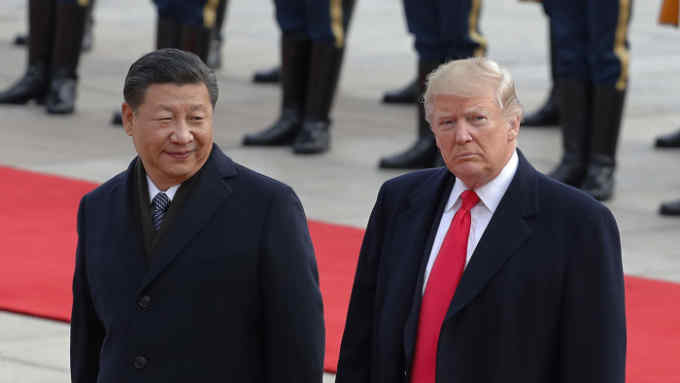 FILE- In this Nov. 9, 2017, file photo U.S. President Donald Trump, right, walks with Chinese President Xi Jinping during a welcome ceremony at the Great Hall of the people in Beijing. Trump is to meet with Xi at the Group of 20 summit in Buenos Aires, Argentina, on Friday, Nov. 30, and Saturday, Dec. 1. (AP Photo/Andy Wong, File)