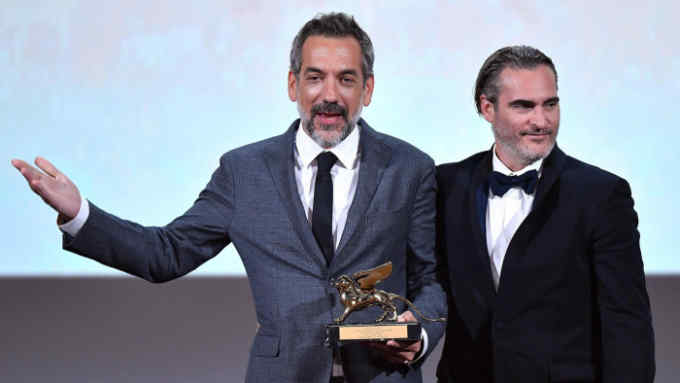 Mandatory Credit: Photo by ETTORE FERRARI/EPA-EFE/Shutterstock (10403950bj) Joaquin Phoenix (R) on stage with US director Todd Phillips (L) who holds the Golden Lion award for his movie 'Joker' during the awarding ceremony of the 76th annual Venice International Film Festival, in Venice, Italy, 07 September 2019. The festival runs from 28 August to 07 September. Award ceremony - 76th Venice Film Festival, Italy - 07 Sep 2019