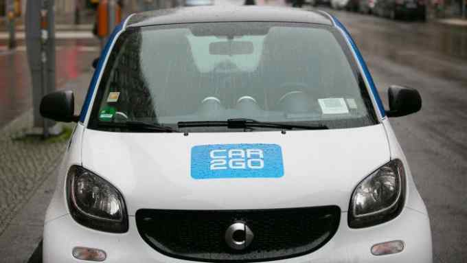 The Car2Go car-sharing logo sits on the hood of a Daimler AG Smart ForTwo automobile as it stands parked on a street in Berlin, Germany, on Wednesday, Dec. 9, 2015. Daimler will review its management structure next year to respond faster to market shifts as Silicon Valley giants plot inroads into the automotive industry. Photographer: Krisztian Bocsi/Bloomberg