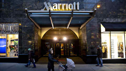 Pedestrians walk past a Marriott International Inc. hotel in Chicago, Illinois, U.S., on Friday, Nov. 30, 2018. A cyber breach in Starwood's reservation system had allowed unauthorized access to information about as many as 500 million guests since 2014. Photographer: Daniel Acker/Bloomberg