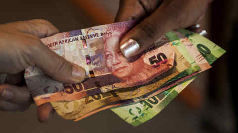 South African rand banknotes sit in this arranged photograph in Pretoria, South Africa, on Monday, Dec. 14, 2015. South Africa's government was left trying to shore up credibility after President Jacob Zuma's debacle over who should run the finance ministry called into question his ability to oversee the economy. Photographer: Waldo Swiegers/Bloomberg