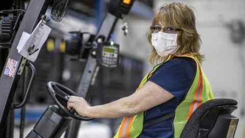 This photo provided by Cindy Parkhurst. shows Cindy Parkhurst working at the Ford Flat Rock Assembly Plant in Flat Rock, Mich.  Like hundreds of workers at Ford, General Motors, Toyota and other companies, Parkhurst has gone back to work to make face shields, surgical masks and even ventilators in a wartime-like effort to stem shortages of protective gear and equipment during the coronavirus pandemic.(Cindy Parkhurst via AP)