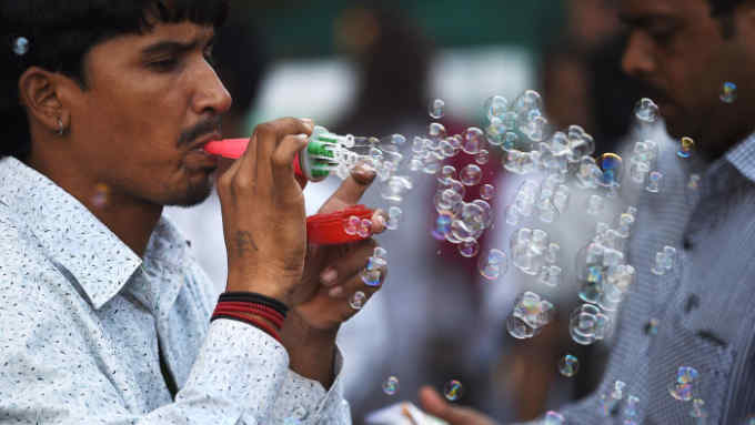 Burst dreams: a young man selling self-made bubble blowers in Mumbai