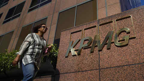 Herbalife Says KPMG Resigns as Auditor Amid Trading Allegations...A pedestrian walks past the offices for the accounting firm KPMG LLP in Los Angeles, California, U.S., on Tuesday, April 9, 2013. KPMG LLP resigned as the auditor for two companies and fired the partner overseeing its Los Angeles audit practice amid allegations the person leaked confidential client information to a third party who used it to make stock trades. Photographer: Patrick T. Fallon/Bloomberg
