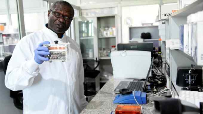 A scientist works in an infectious diseases lab in Nigeria. Health authorities need access to population-specific data