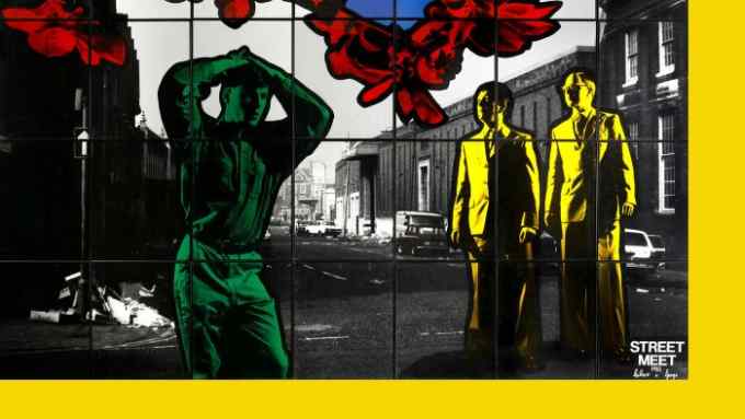A multicoloured photo sectioned into grids with a black and white urban scene in the background, a green man in the foreground and two yellow men in suits to the right