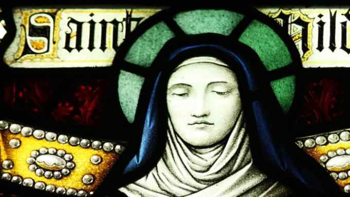 A stained-glass window features the haloed head of St Hilda