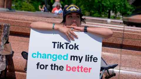 A TikTok content creator at the US Capitol in Washington, with a sign reading ‘TikTok changed my life for the better’