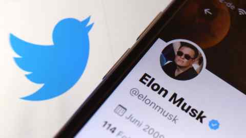 A mobile phone shows Elon Musk’s Twitter page