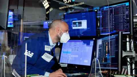 Trading specialist Meric Greenbaum works at his post on the trading floor of the New York Stock Exchange
