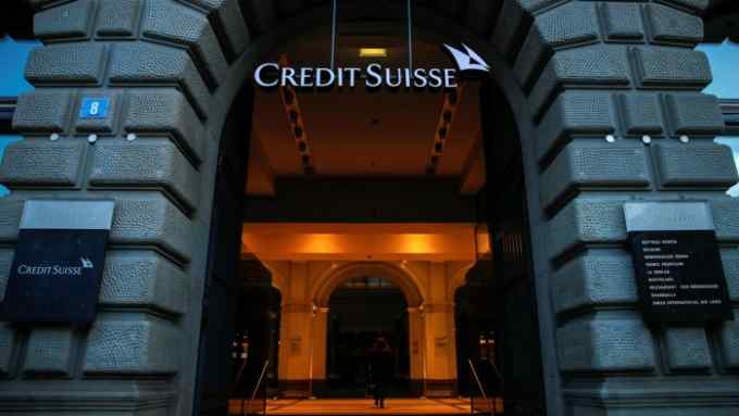 A Credit Suisse logo hangs in the entrance to Credit Suisse Group AG’s headquarters in Zurich, Switzerland