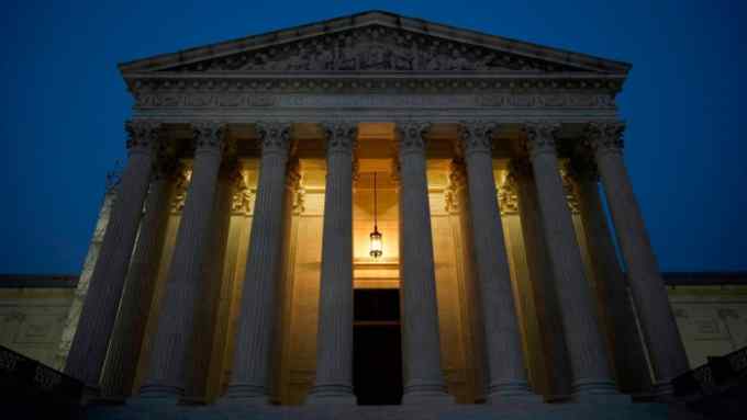 The US Supreme Court is shown at dusk