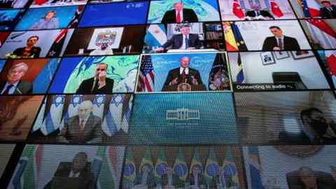 World leaders are seen on a screen as US president Joe Biden delivers his remarks during a virtual Leaders Summit on Climate on Thursday
