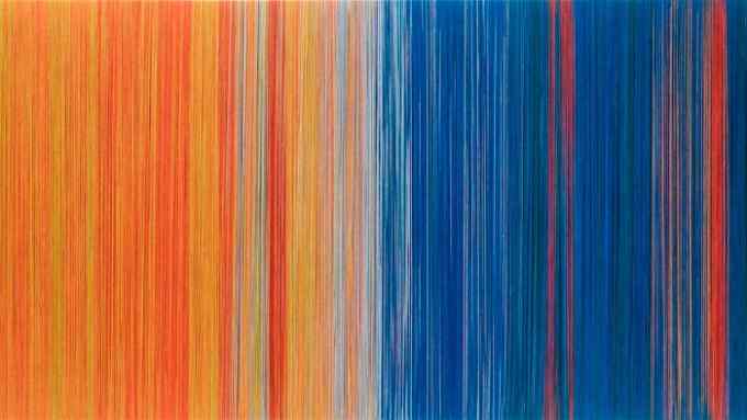 A long landscape work of red and orange vertical threads on the left changing to blue on the right