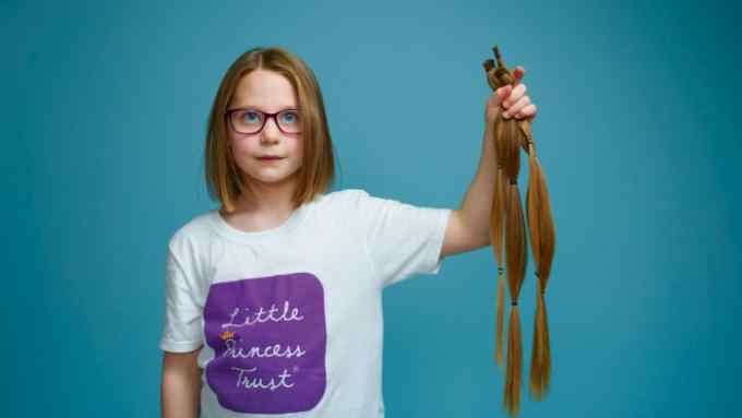Seven-year-old Mae Bagladi with her 16in hair donation
