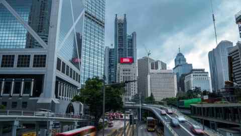 A banner displays a message marking the centenary of the Chinese Communist party and the the anniversary of Hong Kong’s return to Chinese rule atop the Bank of China building