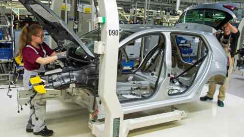 Workers put together a Volkswagen Golf, a best-seller for the group