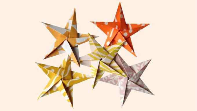 Folded paper five-pointed stars in orange, yellow and pink patterns