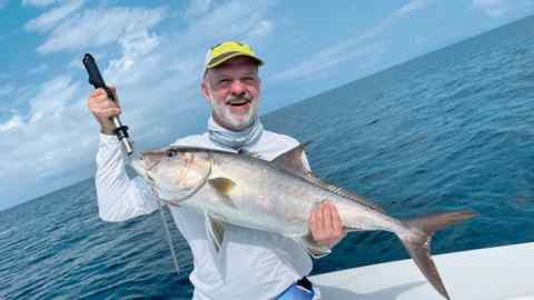 Robert Armstrong holds an amberjack fish caught off the coast of Colombia