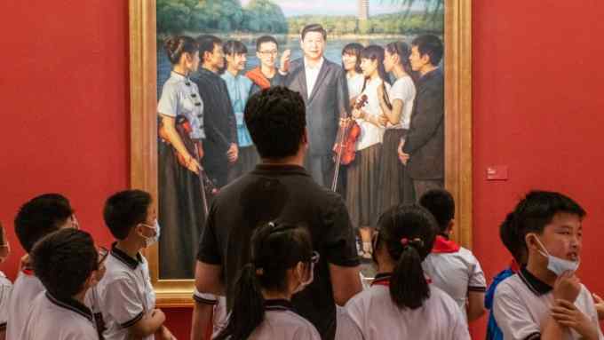 Visitors in front of a portrait of Xi Jinping at the National Art Museum in Beijing during the exhibition ‘100 years toward greatness’ on June 30, 2021