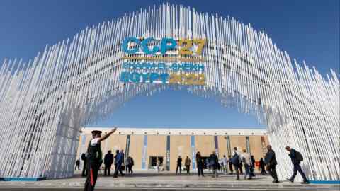 A police officer stands in front of the entrance of the Sharm El Sheikh International Convention Centre during the COP27 climate summit