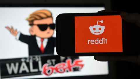 Photo illustration shows the logo of Reddit forum r/WallStreetBets on a computer and the Reddit logo on a mobile phone