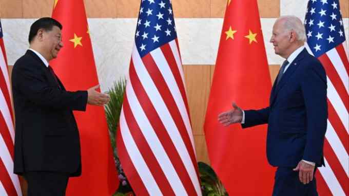 US President Joe Biden (R) and China’s President Xi Jinping (L) shake hands as they meet on the sidelines of the G20 Summit in Nusa Dua on the Indonesian resort island of Bali on November 14, 2022
