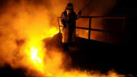 A worker processes liquid steel at an ArcelorMittal steel factory in Zenica, Bosnia and Herzegovina