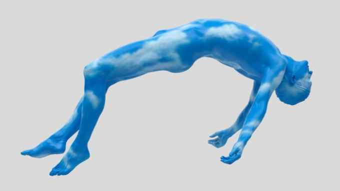 Lifesize sculpture of a man as if falling through space, but his skin is blue sky with clouds