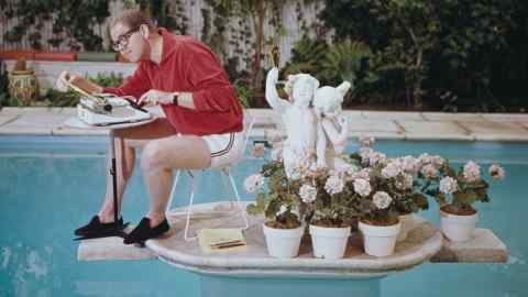 Comedian Stan Freberg working in his swimming pool in 1962