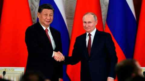 Xi Jinping and Russian president Vladimir Putin shake hands during the Chinese leader’s state visit to Moscow this week